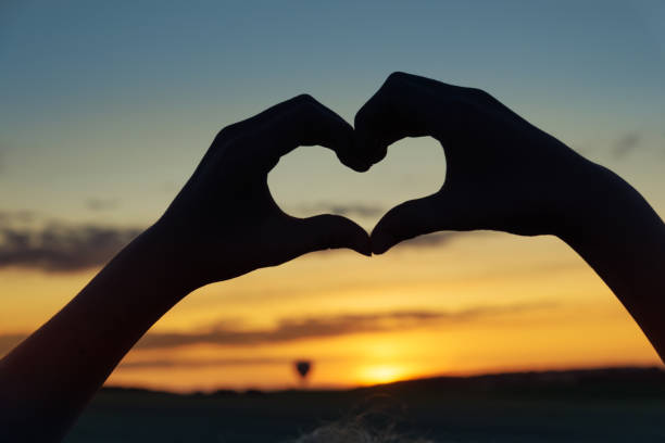 istock Heart silhouette at sunset 1175084982