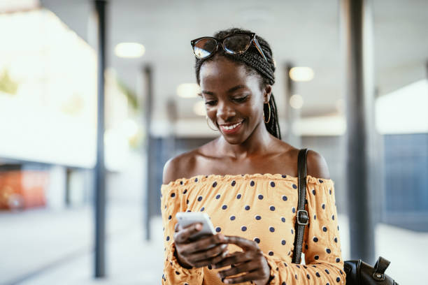 istock African millennial woman using mobile phone 1175086523