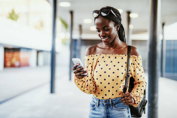 istock Black millennial woman using mobile phone 1175087350