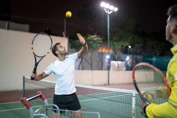 istock Teaching a guy how to play tennis 1175088270