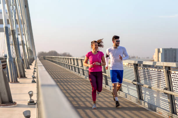 istock Couple jogging at the bridge 1175088285