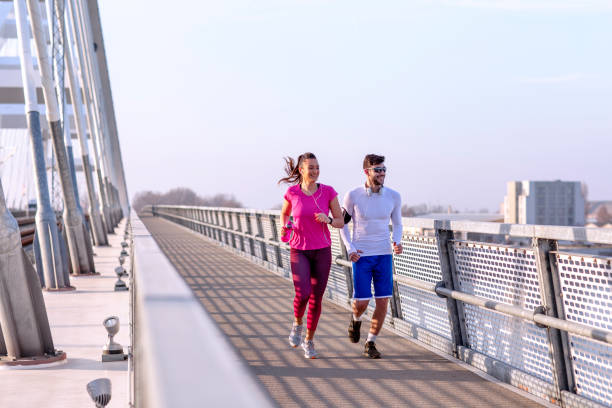 istock Couple jogging at the bridge 1175088295