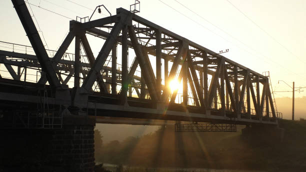 istock Drone view Double railway bridge over river in morning fog 1175090679