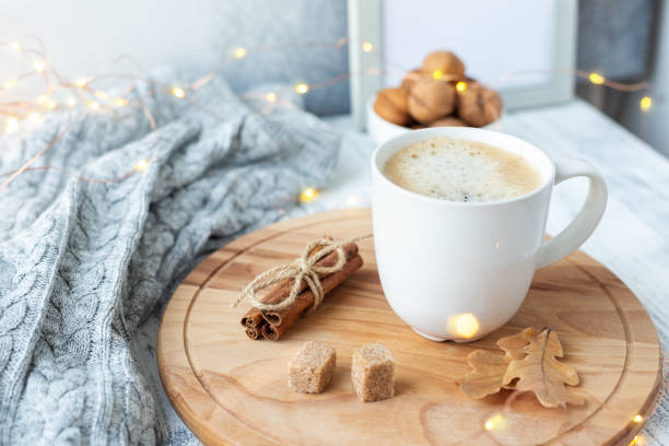 istock Coffee mug, sweater, cinnamon, decorated with led lights. Autumn mood. Cozy autumn composition. Hygge concept Soft focus 1175091704