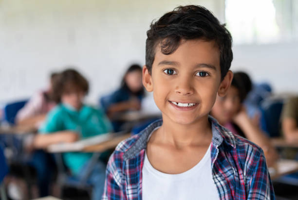 istock Boy at the school looking very happy in the classroom 1175092404