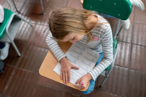 istock Girl at the school taking notes in class 1175092588