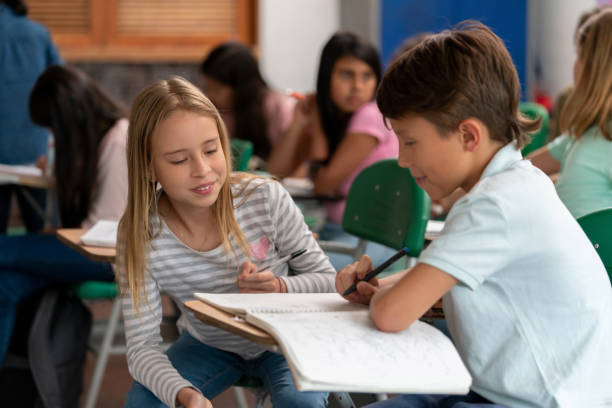 istock Happy kids studying together at the school 1175096226