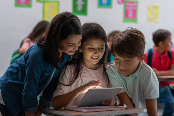 istock Happy kids at the school using technology to learn 1175096316