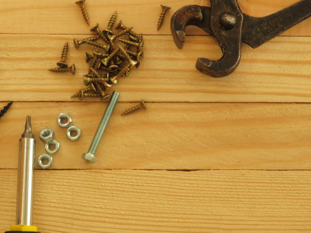 istock Set of tools. Drill, screws, screwdriver, pliers. Wood background. 1175096829