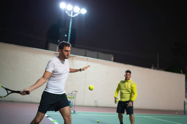 istock Teaching a guy how to play tennis 1175099610