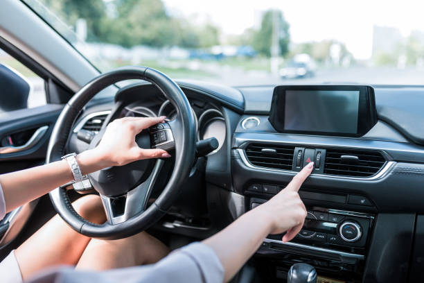 istock Close-up, female hand includes an emergency stop button, turning on dimensions, accident on road. The interior of car in summer in city, an alarm and accidents on highway. 1175102661