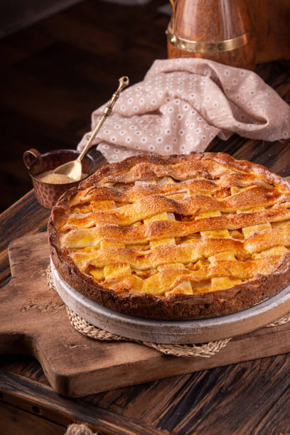 istock Homemade sweet pie cake with peach on white board 1175103214