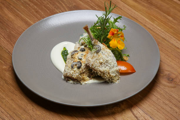 istock Crispy duck legs served with arugula and decorated with edible flowers. Exquisite dish. Creative restaurant meal concept. 1175103328