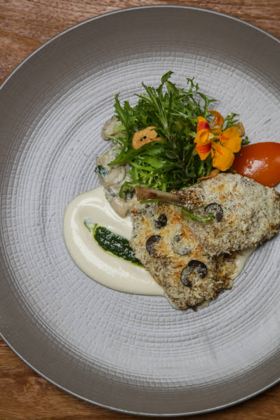 istock Crispy duck legs served with arugula and decorated with edible flowers. Exquisite dish. Creative restaurant meal concept. 1175103495