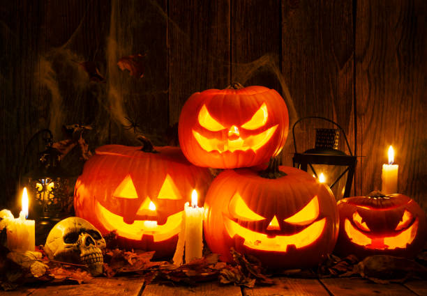 istock Halloween Jack-o-Lantern Pumpkins on rustic wooden background 1175106230