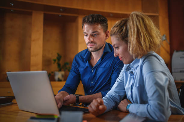 istock Two Business Coworkers Brainstorming at Workstation 1175106742