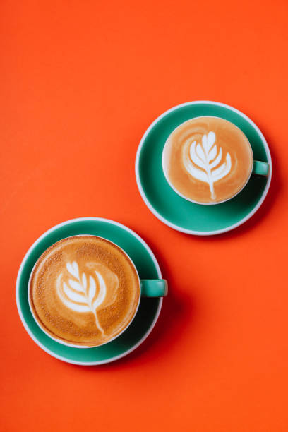 istock Cyan coffee cups over orange background. 1175111425