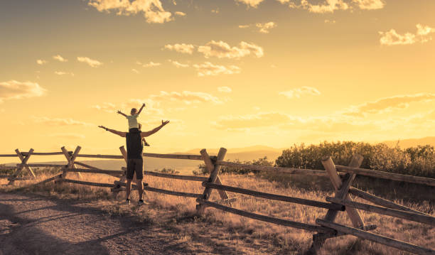 istock Happy father and his little sun having fun outdoors at sunset. 1175112198