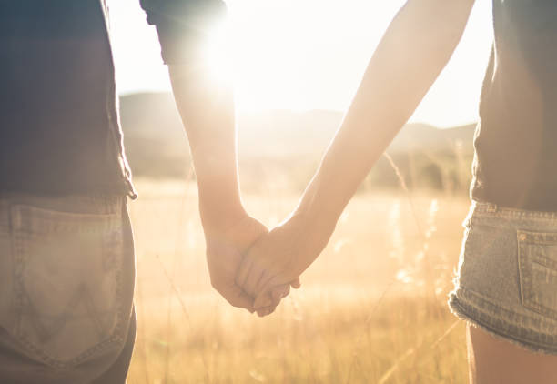 istock Young couple holding hands at sunset. 1175112268