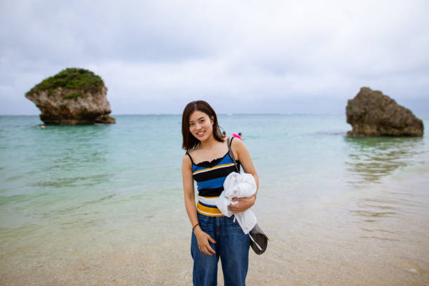 Young woman standing on resort beach