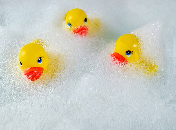 yellow ducks in bubble bath stock photo