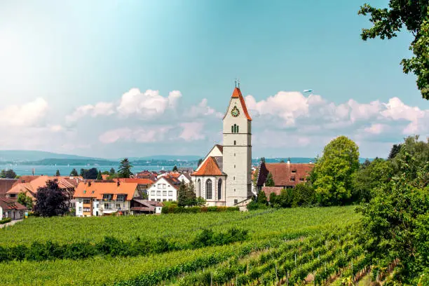 Panoramic view of lake of Lake Constance. Zeppelin, apple trees and Catholic Church St. Johann Baptist in Hagnau on the picture.