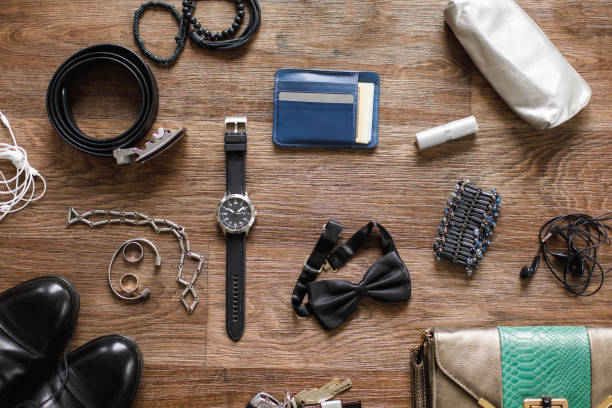 Directly above shot of man's shoes, clutch bag, wrist watch, belt, bow tie, different jewelry and other personal possessions for elegant night out.