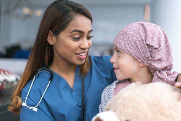 istock Kind doctor comforts girl with cancer 1175130151