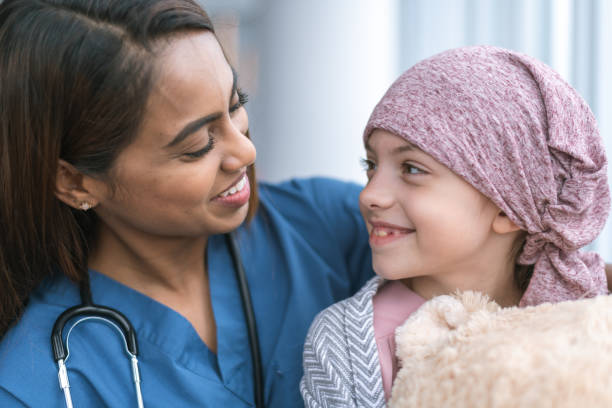 istock Kind doctor comforts girl with cancer 1175130157