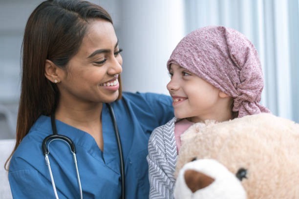istock Kind doctor comforts girl with cancer 1175130161
