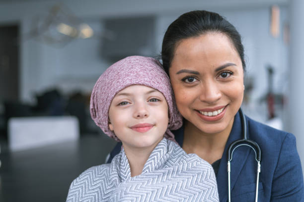 istock Kind doctor comforts young girl with cancer 1175130186