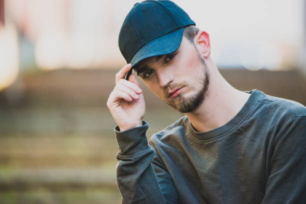 istock Close up portrait of a young bearded man wit cap looking at camera with copy space for text 1175132680