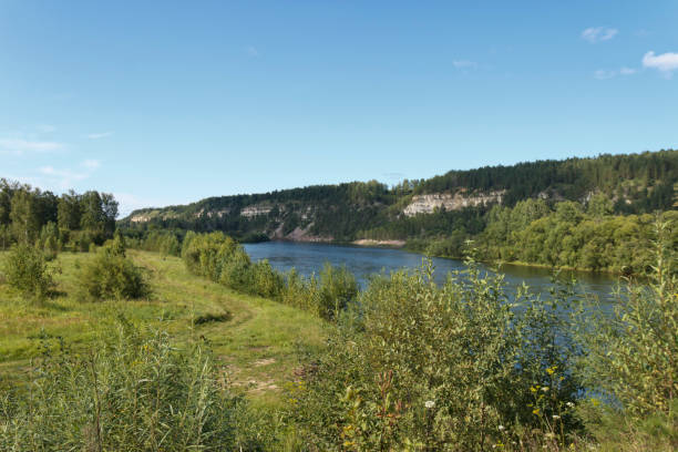 istock beautiful banks of a quiet river, summer day 1175140813