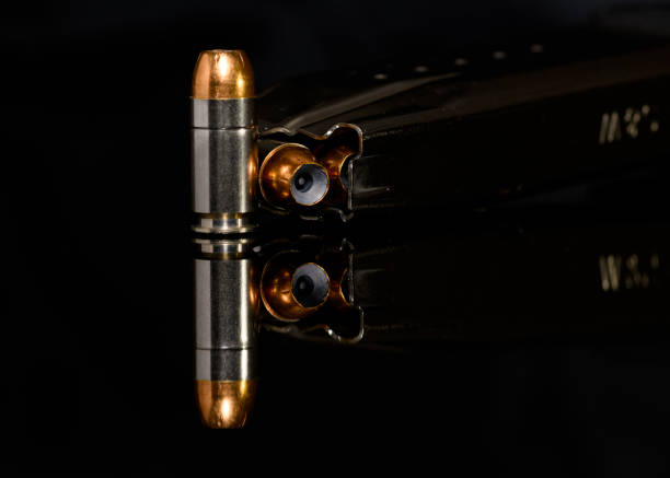 istock 40 Caliber ammunition with magazine on black background 1175140960