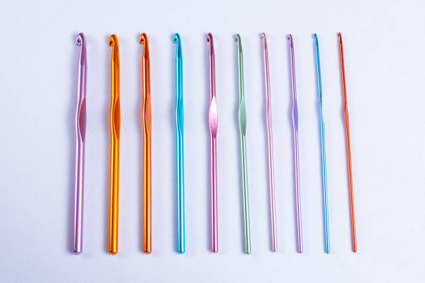 istock Crochet hooks of different sizes and colors arranged in one row, rainbow palette 1175141096