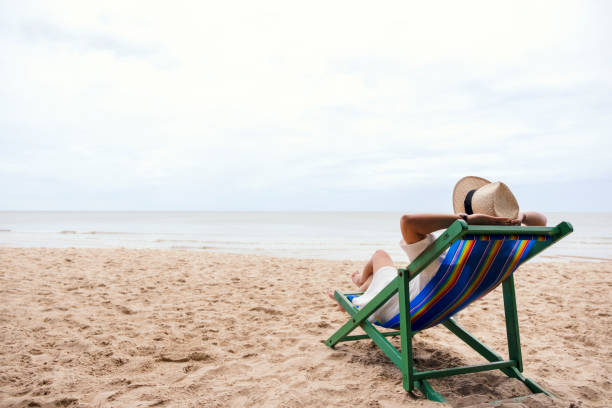 istock A woman lying down on a beach chair 1175142767