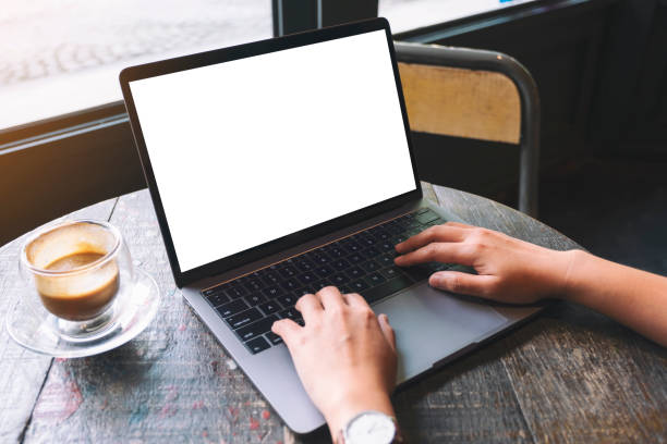 istock a woman using and typing on laptop keyboard with blank white desktop screen on wooden table 1175142768