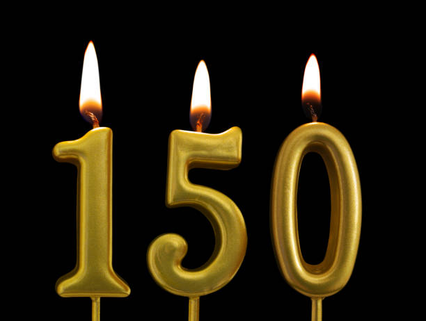 istock Golden birthday candles on black background, number 150 1175146887