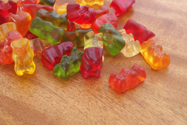 istock Gummy bears candies on wooden background 1175148543