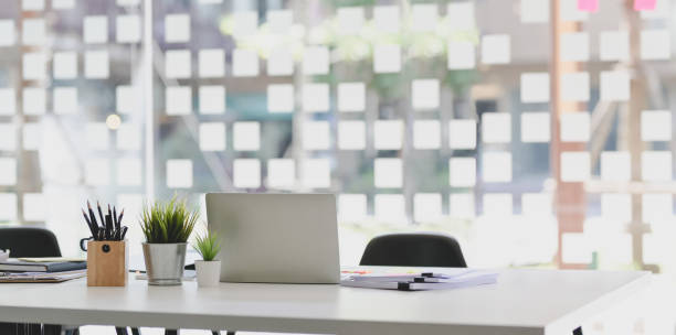 istock Modern office style with open laptop computer with office supplies and documents 1175149457
