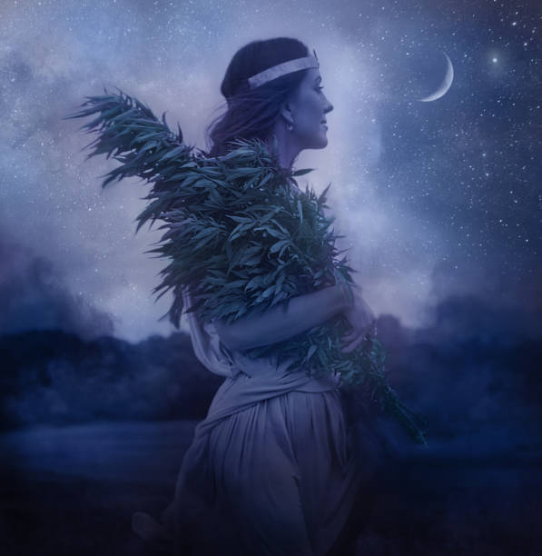istock Cannabis Goddess holding bundle of cannabis plants and night sky 1175151072