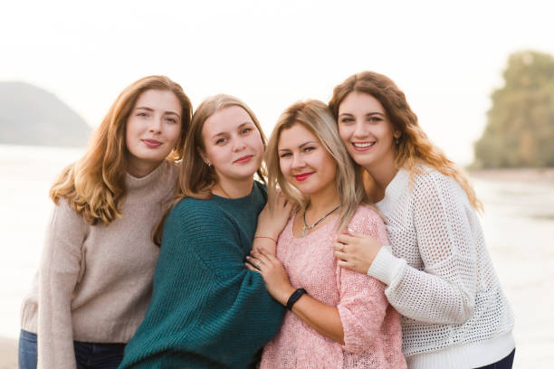 istock Cheerful girlfriends having fun on the beach 1175151453