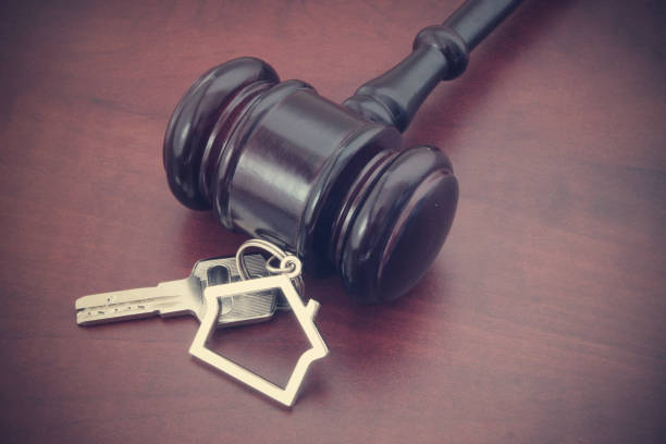 istock Judge gavel and key with house shape holder 1175151532