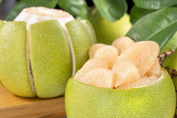 istock Fresh peeled pomelo, grapefruit, shaddock on bright wooden table background. Seasonal fruit for Mid-Autumn Festival. 1175152666