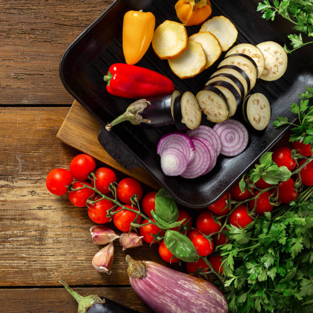istock Raw vegetables for cooking on a grill pan on wooden background top view 1175154828
