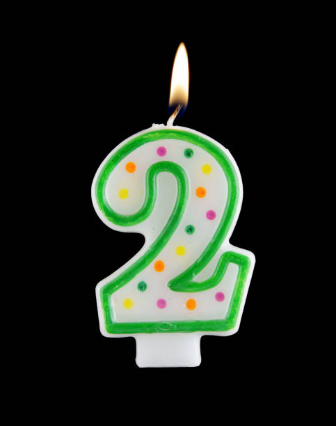 istock Birthday candle on black background, number 2 1175154846