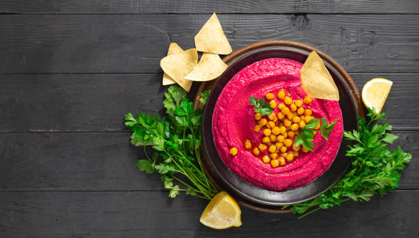 istock Beetroot hummus in a plate on a dark background top view 1175155520