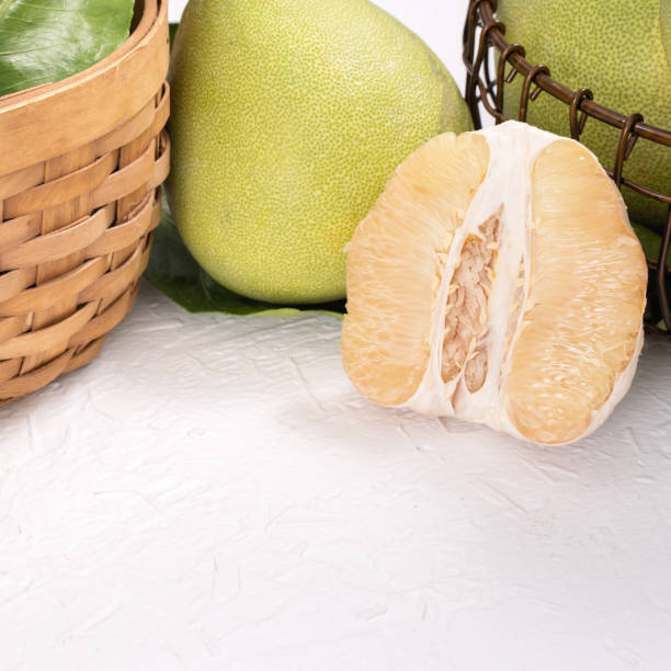 istock Fresh peeled pomelo, pummelo, grapefruit, shaddock on bright wooden table background. Seasonal fruit for Mid-Autumn Festival. 1175156149