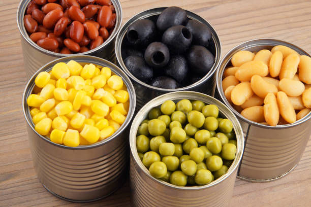 istock Canned food on wooden background 1175159421