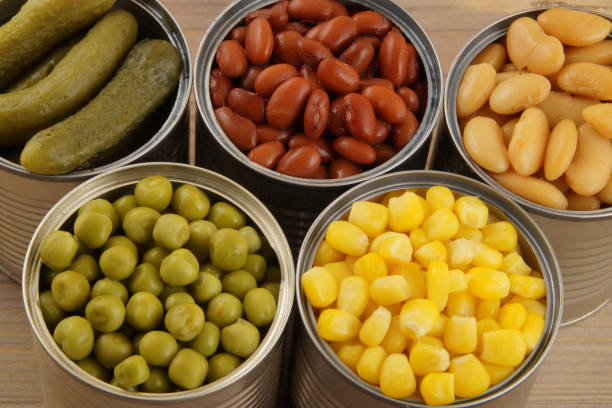 istock Canned food on wooden background 1175159528